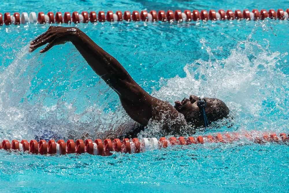 An adult swimmer training confidently in a lane of the pool